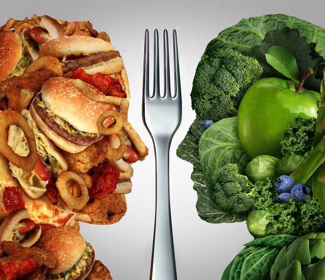 Life At The Table Bad Diets Kill More People Than Smoking | Two heads looking at each with a fork in between them. One head is made out of junk food, pizza, burgers, etc. The other head is made out of broccoli, green apple, cabbage, etc.