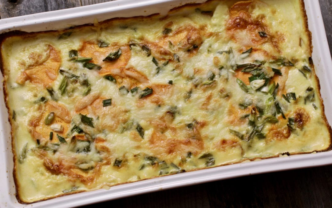 Sweet Potato and Poblano Gratin in a baking tray on top of a wooden table | Life at the Table