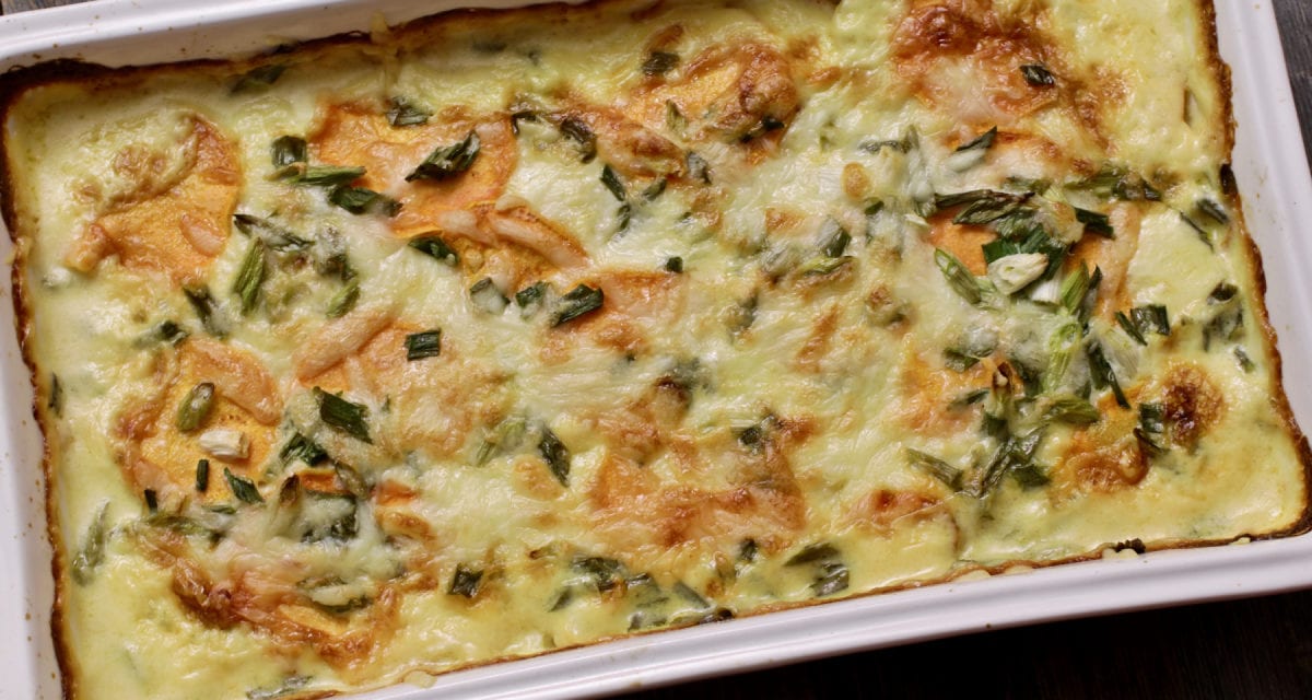 Sweet Potato and Poblano Gratin in a baking tray on top of a wooden table | Life at the Table