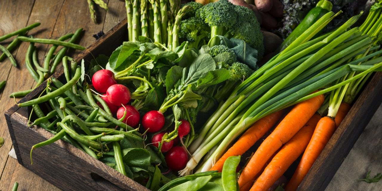 Life At The Table Live, Virtual Cooking Classes. Box of farm fresh vegetables in a wooden box including radish, carrot, green beans, green bell pepper.