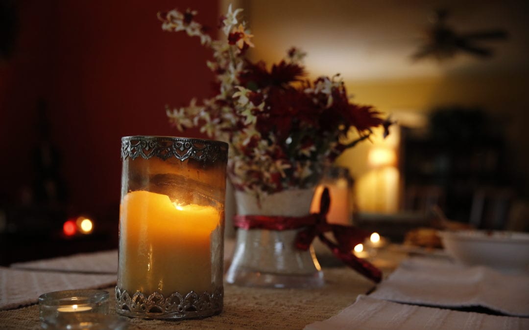 It's Better When Shared | Life At The Table. Candle and flower arrangement on top of a dining table.