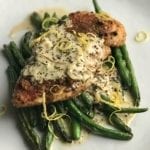 Life At The Table | Pistachio Crusted Chicken with Mustard Cream Sauce. Pan-seared chicken breast atop a bed of sautéed green means with a mustard cream sauce garnished with zest of lemon.