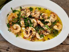 Life At The Table Shrimp al Ajillo. Shrimp al ajillo on a white plate garnished parsley.