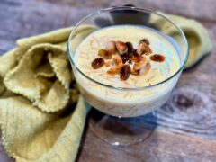 Life At The Table Payasam. Paysam in a dessert coupe on wooden table with a green napkin beside it.