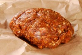 Life At The Table Homemade Mexican Chorizo. A bulk of homemade Mexican chorizo sitting on brown, wrinkled parchment paper.